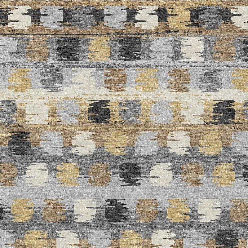 Abstract area rug close-up with distressed gray, cream, black, and gold blocks
