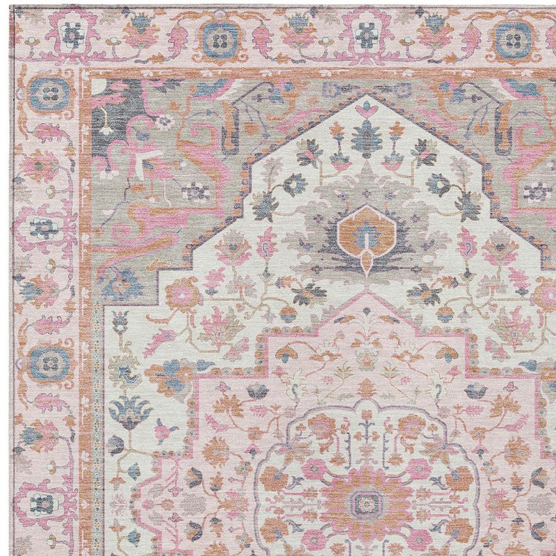 Pink and gray oriental rug close-up showing central shield and floral motifs