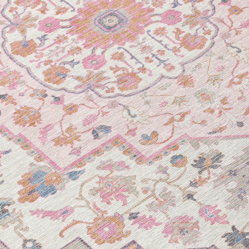 Close-up of pink, gray, and cream oriental rug pattern with floral and geometric details