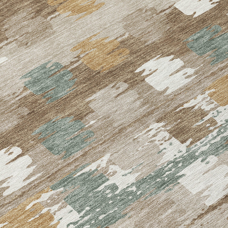 Abstract area rug close-up in brown, aqua, gold, and cream distressed print