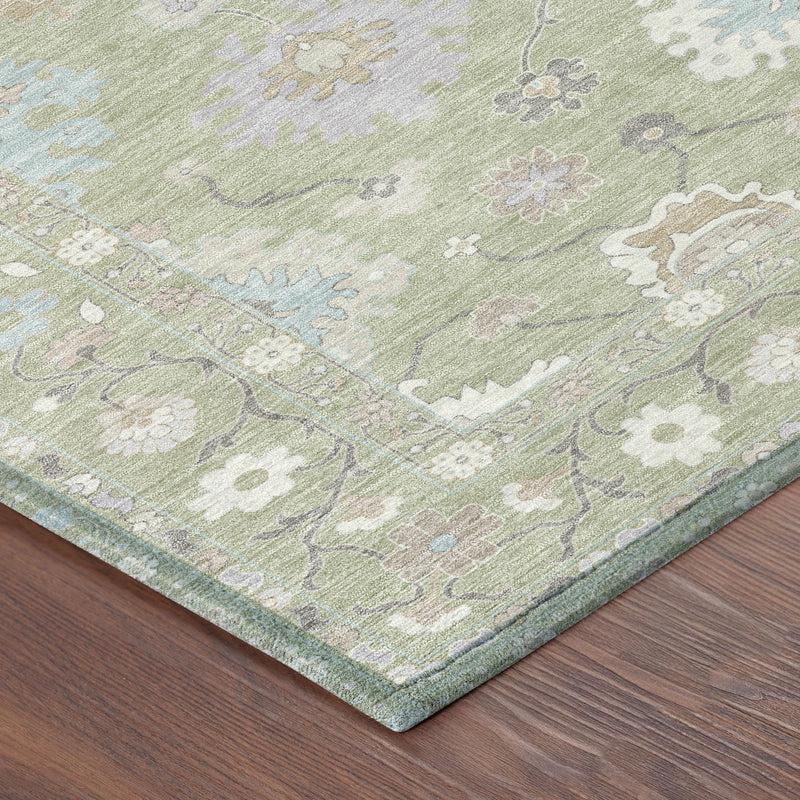Corner view of light green oriental area rug with teal and cream floral motifs