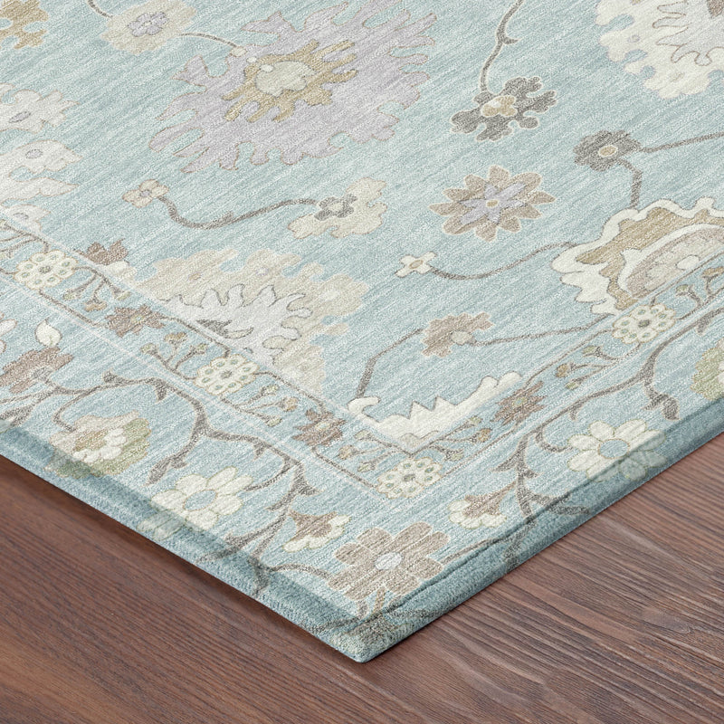 Corner view of sky blue oriental rug with beige floral and scrollwork border