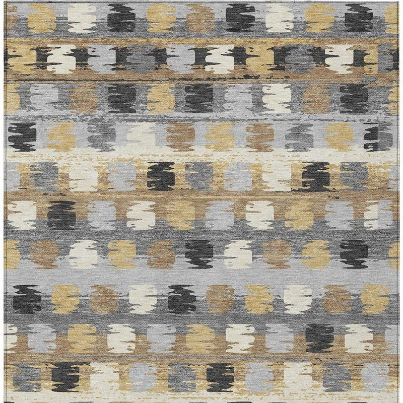 Abstract gray area rug with scattered beige and gold textured block pattern.