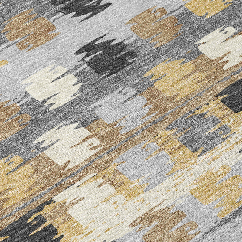 Close-up abstract area rug with gray base, beige blocks, and gold and brown streaks.