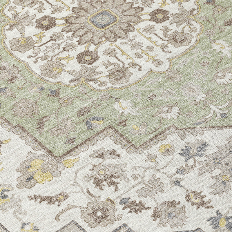 Closeup of green oriental rug with cream, yellow, and brown floral motifs