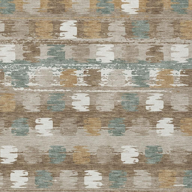 Close-up abstract rug pattern in beige, brown, and aqua with worn, textured rectangle shapes.