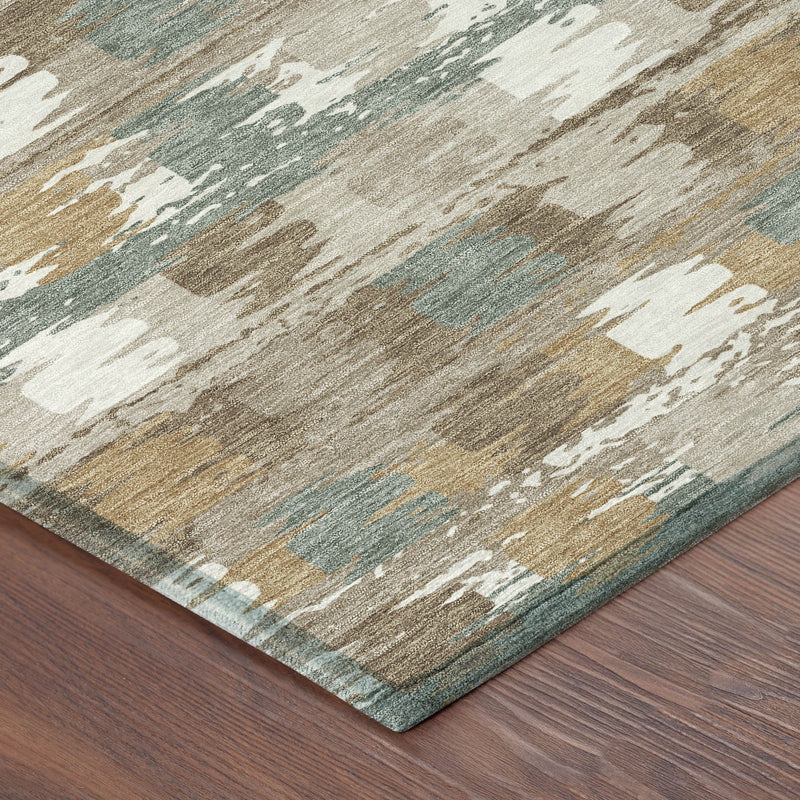 Rug corner detail with beige and brown base, aqua accents, and distressed abstract pattern.