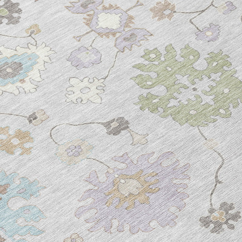 Gray area rug close-up with multicolor floral and medallion motifs; textured flat weave.