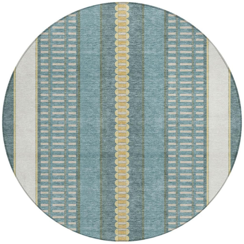 Round area rug with teal blue, gold, and cream stripes and repeating grid detailing