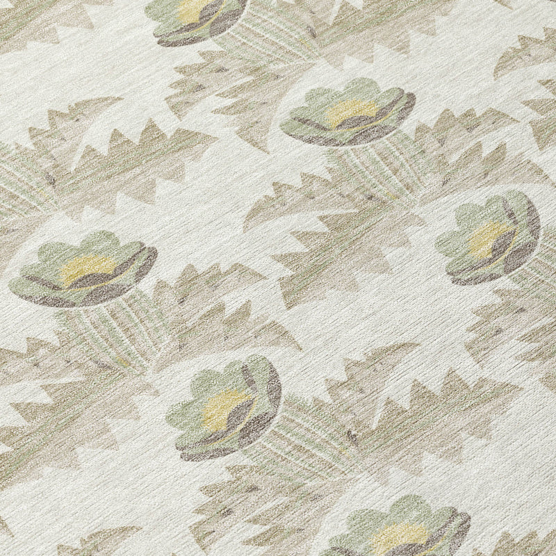 Close-up of round area rug fabric, ivory with repeating green and yellowish flower prints