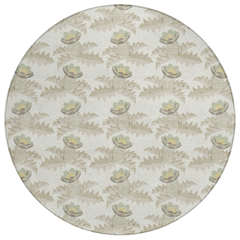 Round area rug, ivory field with patterned flowers and jagged leaf shapes in muted greens