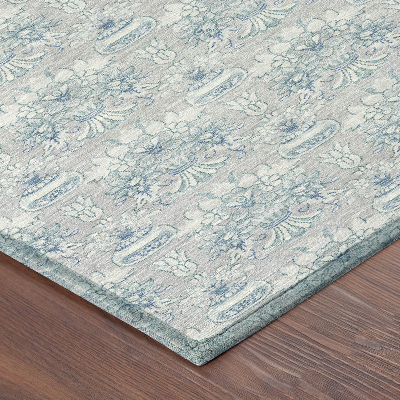 Corner detail of indoor outdoor area rug with textured pile and blue floral design