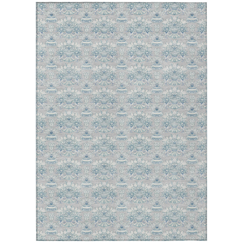 Indoor outdoor area rug shown flat on a white background, blue floral pattern on gray