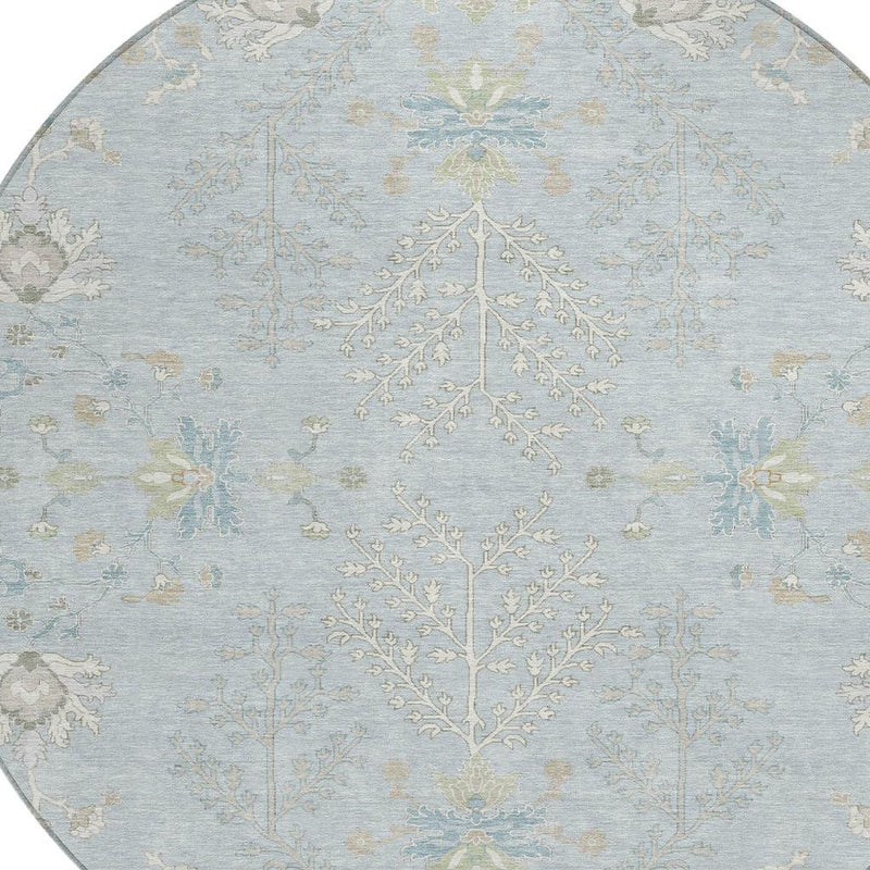 Round sky blue area rug with ivory central tree motif and ornate florals