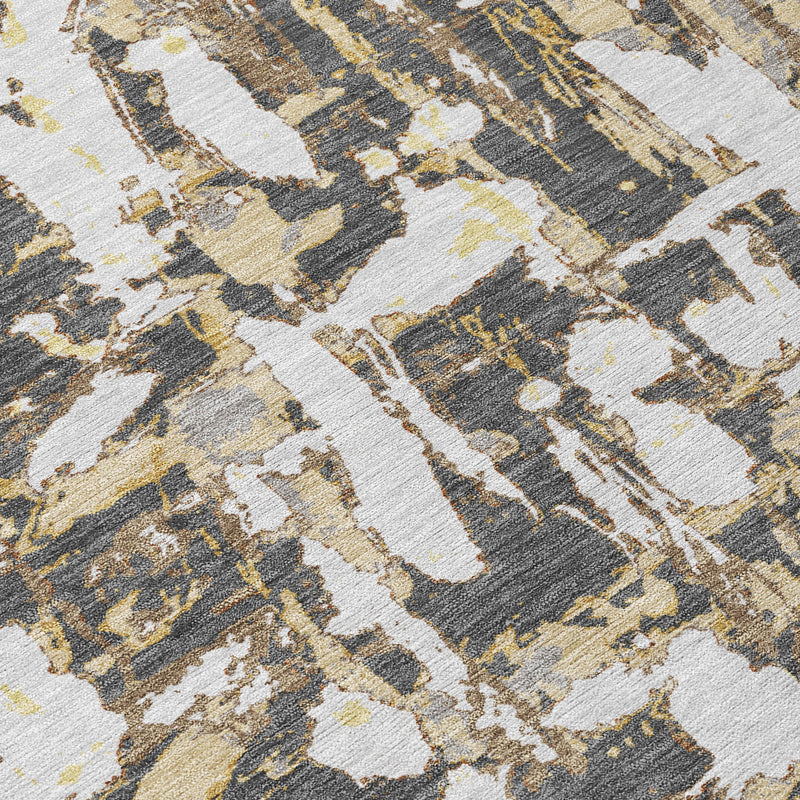 Abstract area rug close-up showing distressed graphite, ivory, and olive motifs.