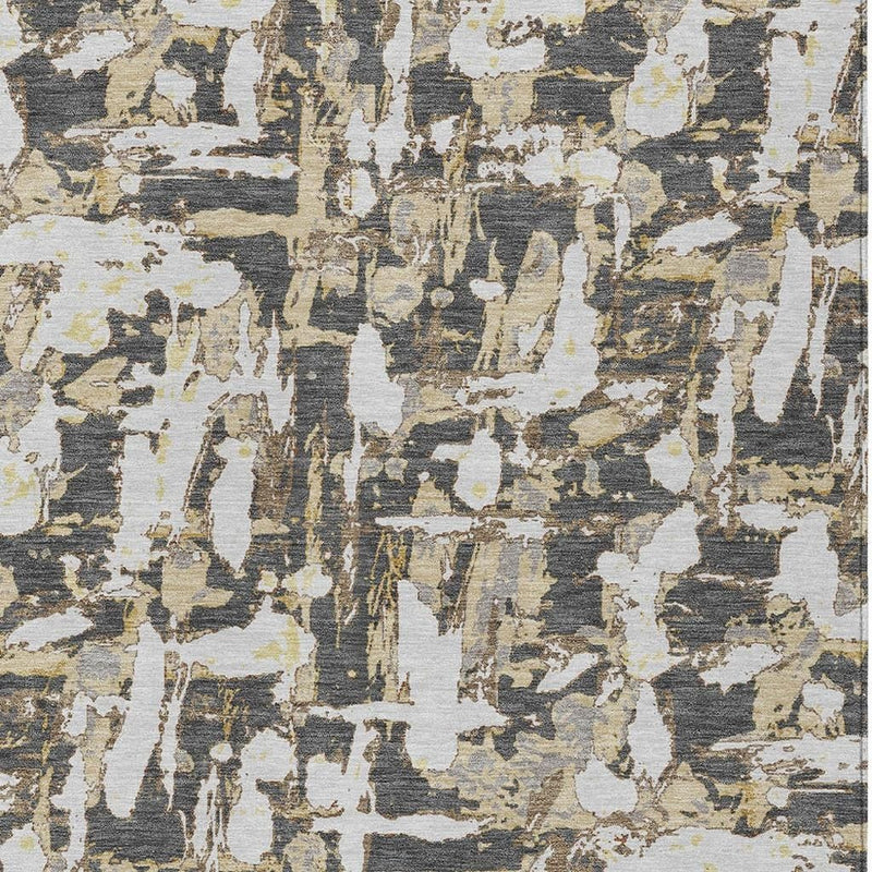 Abstract area rug close-up with dark, light, and olive irregular blocks.