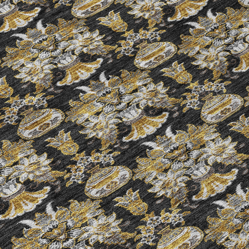 Close-up of black area rug with gold and cream floral damask medallions