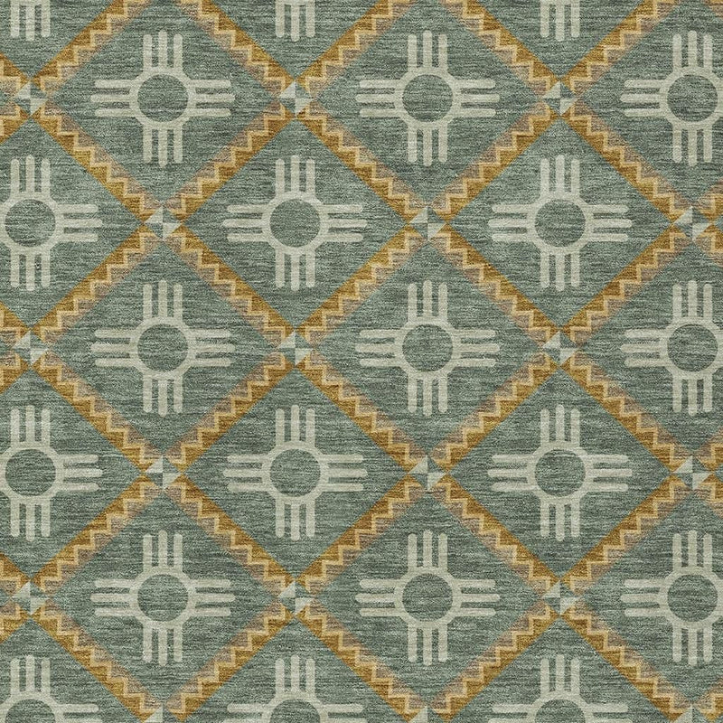 Teal-green area rug with repeating cream sun-and-hand diamond geometric pattern, close-up