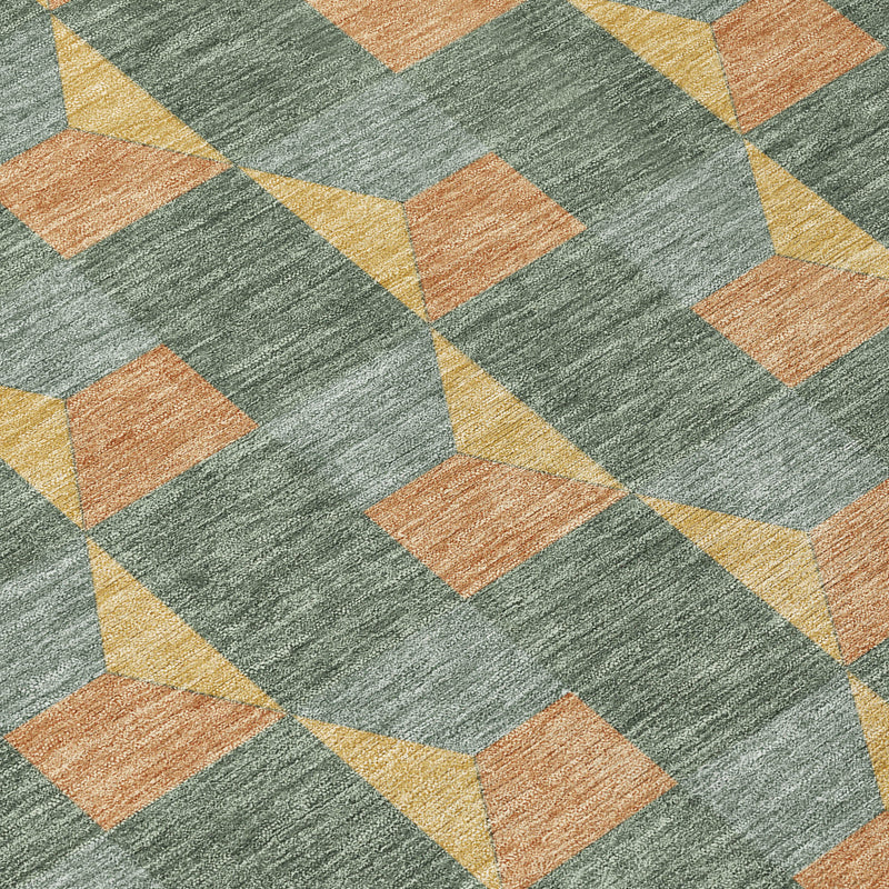 Diagonal view of green-gray geometric area rug with tan-orange and yellow cube pattern