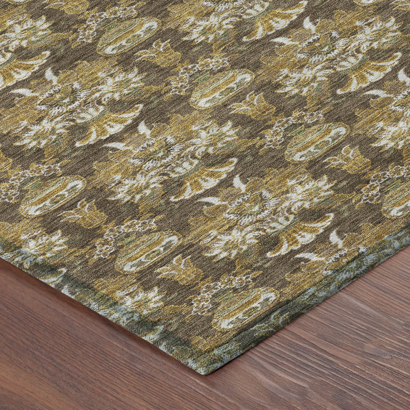 Corner of floral patterned area rug with repeating damask motifs in brown and gold