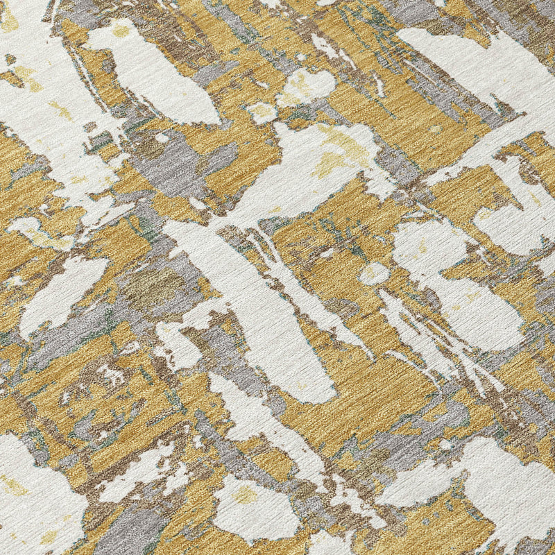 Close-up of gold, ivory, and light gray abstract distressed rug pattern with textured texture