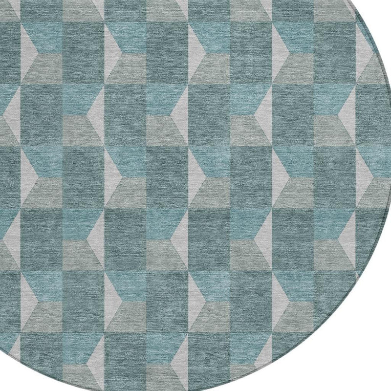 Round rug with teal and gray geometric design and beige block accents