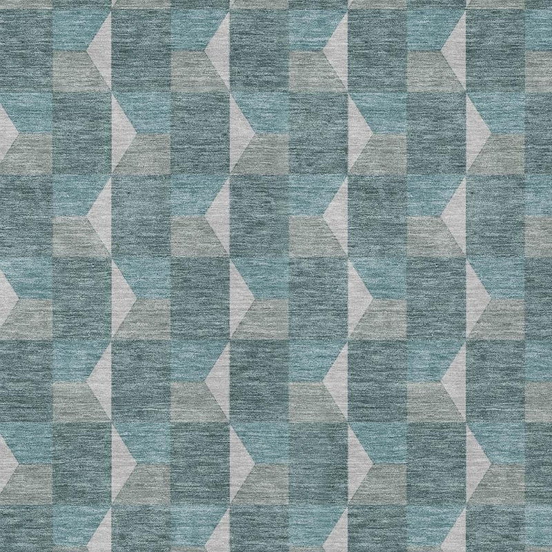 Teal and gray geometric area rug close-up with white angled cube-like shapes