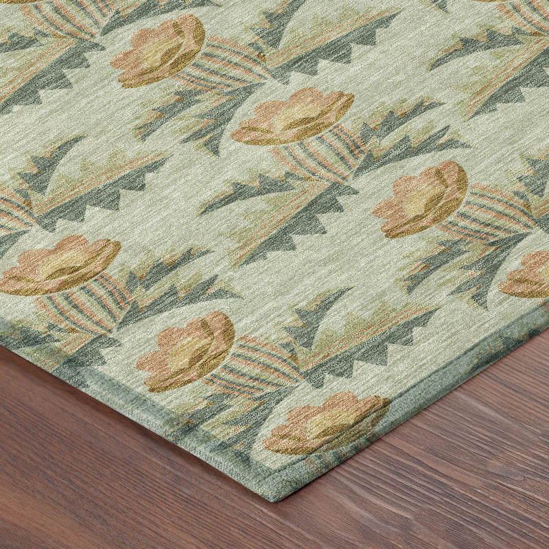 Floral area rug corner with stitched edge and repeating tulip motifs on sage