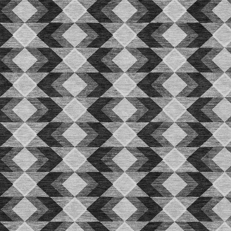 Geometric area rug pattern in black, gray, and white with repeating diamond motifs