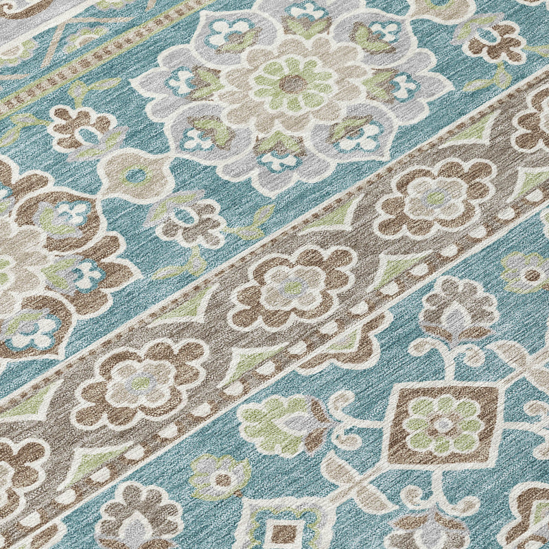 Close-up tribal area rug with teal, blue, green and beige floral and diamond pattern
