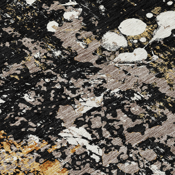Abstract area rug with black base, silver-gray spots, and gold flecks