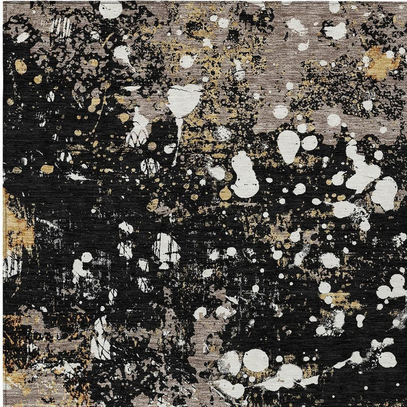 Rectangular abstract area rug with black, silver-gray, white blotches, and gold specks
