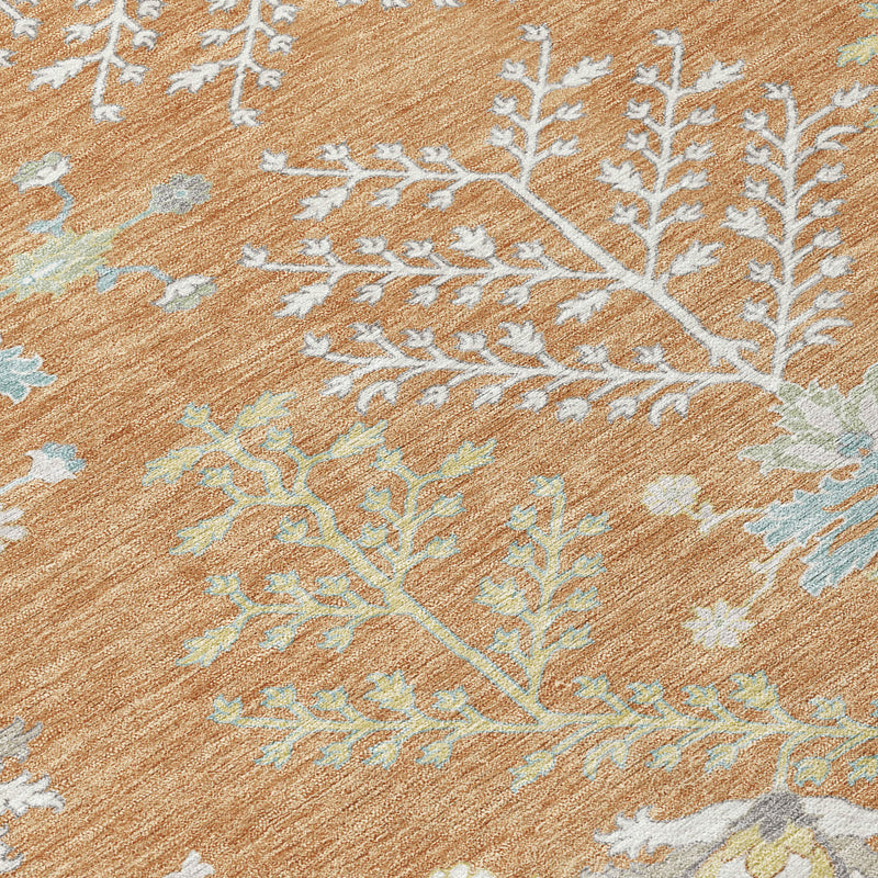 Close-up of copper-brown rug texture with ivory and light blue botanical pattern