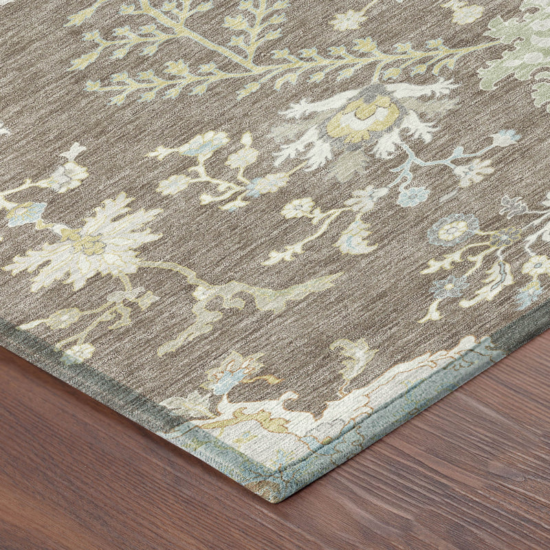Taupe area rug corner with ivory and blue floral pattern, folded edge