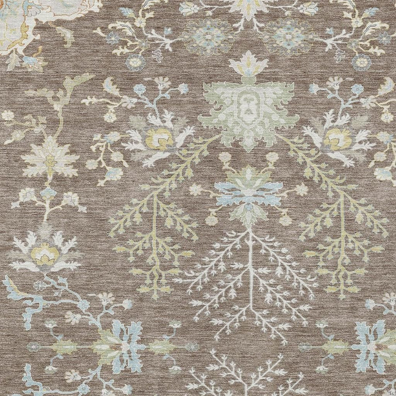 Taupe area rug with ornate ivory and blue botanical pattern, close-up