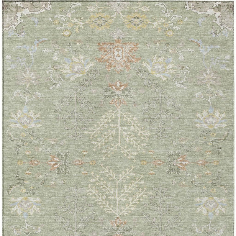 Straight-on view of green area rug with ivory floral lattice and central orange medallion
