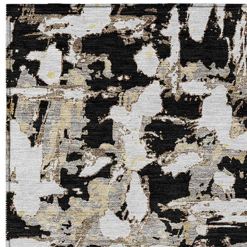 Abstract area rug with scattered black shapes and copper flecks on cream ground.