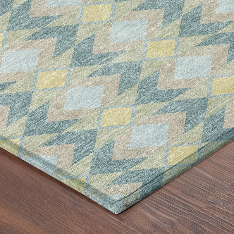 Teal blue geometric area rug with diamond and zigzag motifs, visible corner edge