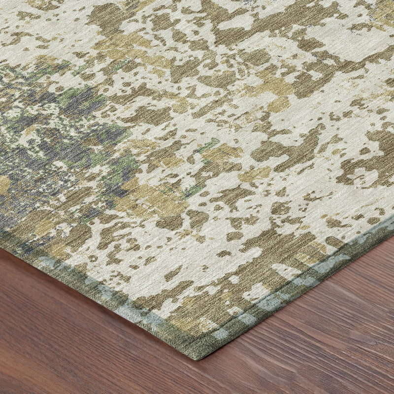 Corner of ivory abstract rug with tan and olive distressed pattern and speckled texture
