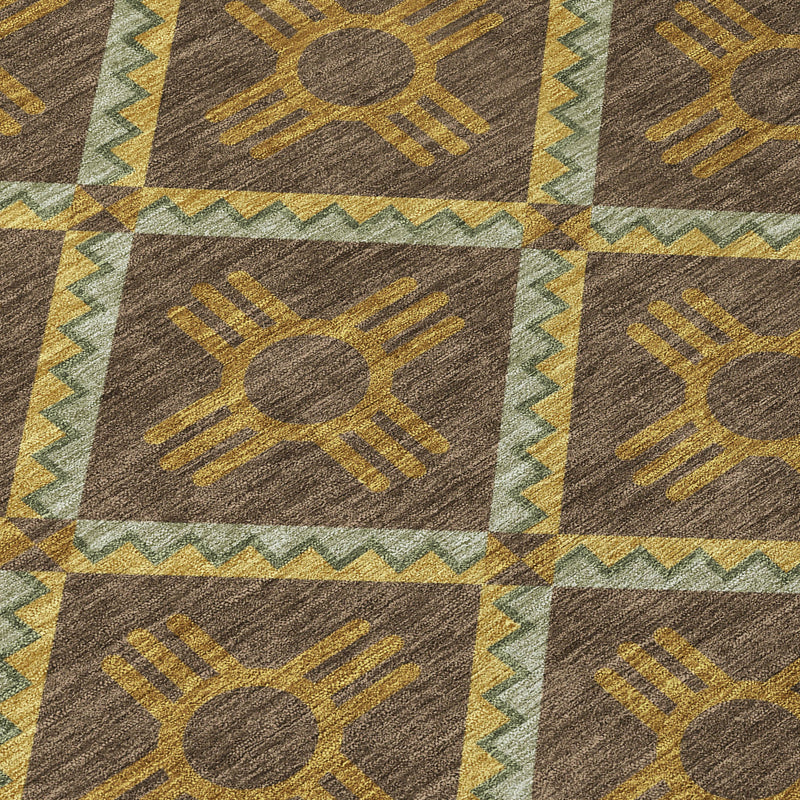 Close-up geometric area rug with brown, taupe, and mustard diamond motifs