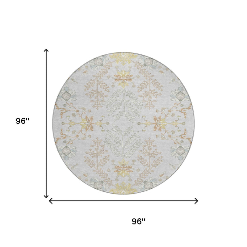 Round area rug with light gray background and symmetrical ivory, gold, and muted blue florals
