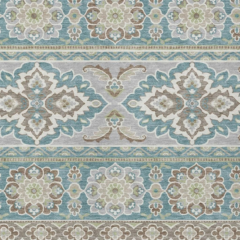 Teal blue and green floral tribal area rug close-up with geometric stripe border