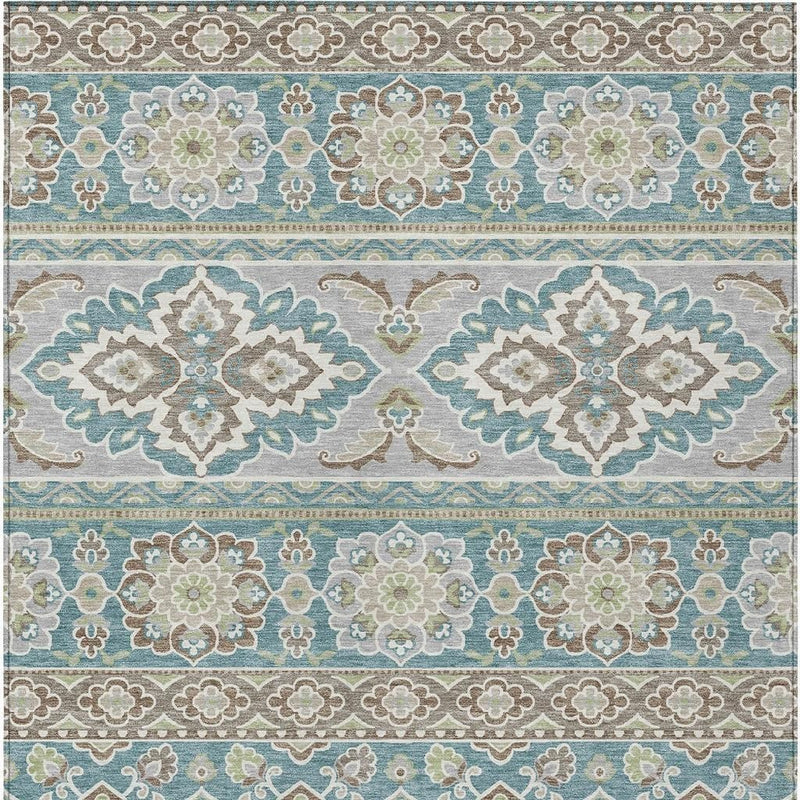 Teal and green tribal area rug pattern close-up with diamond motifs and border trim