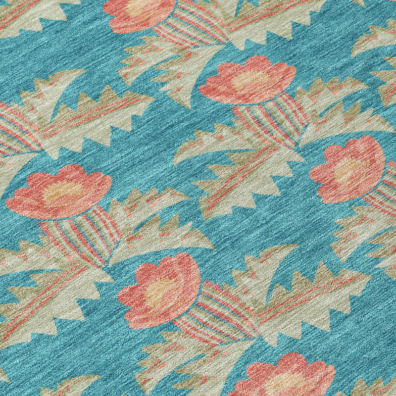 Turquoise floral area rug close-up with coral flower heads and leaf-like motifs
