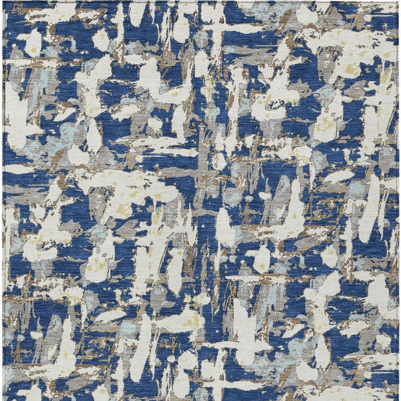 Abstract flat-weave area rug showing repeating blue and cream distressed blocks.
