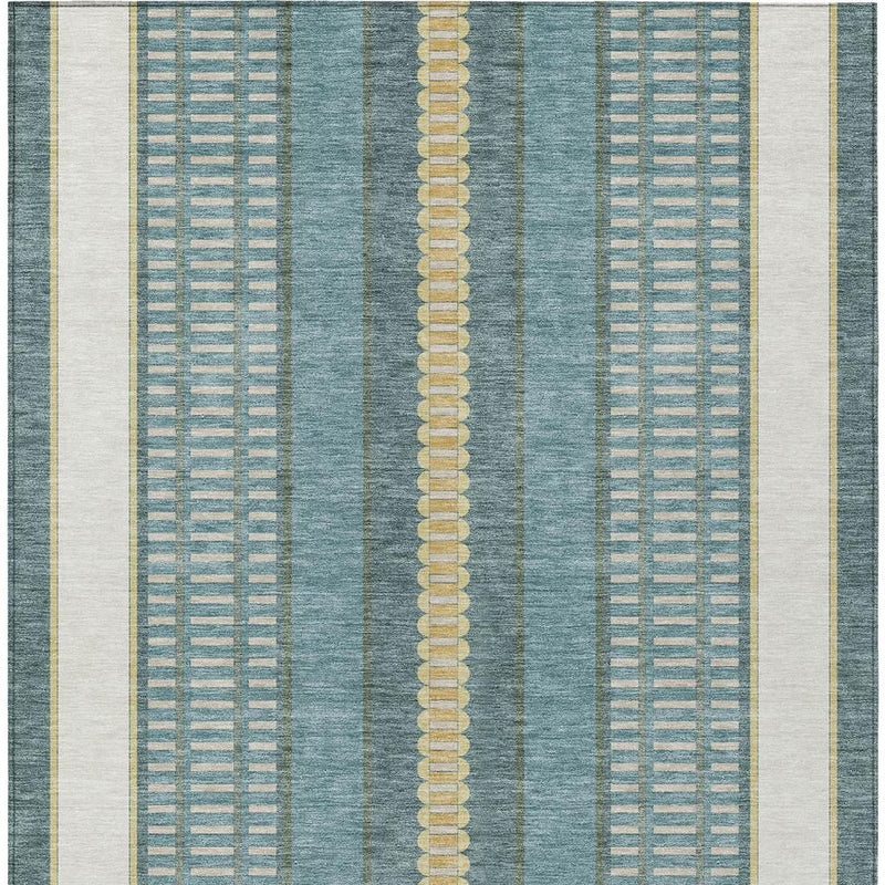 Teal blue area rug close-up with vertical stripe bands and beige-gold dotted trim