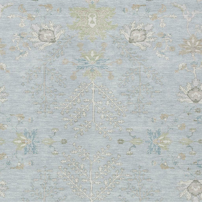 Sky blue area rug with ivory floral and tree motif pattern