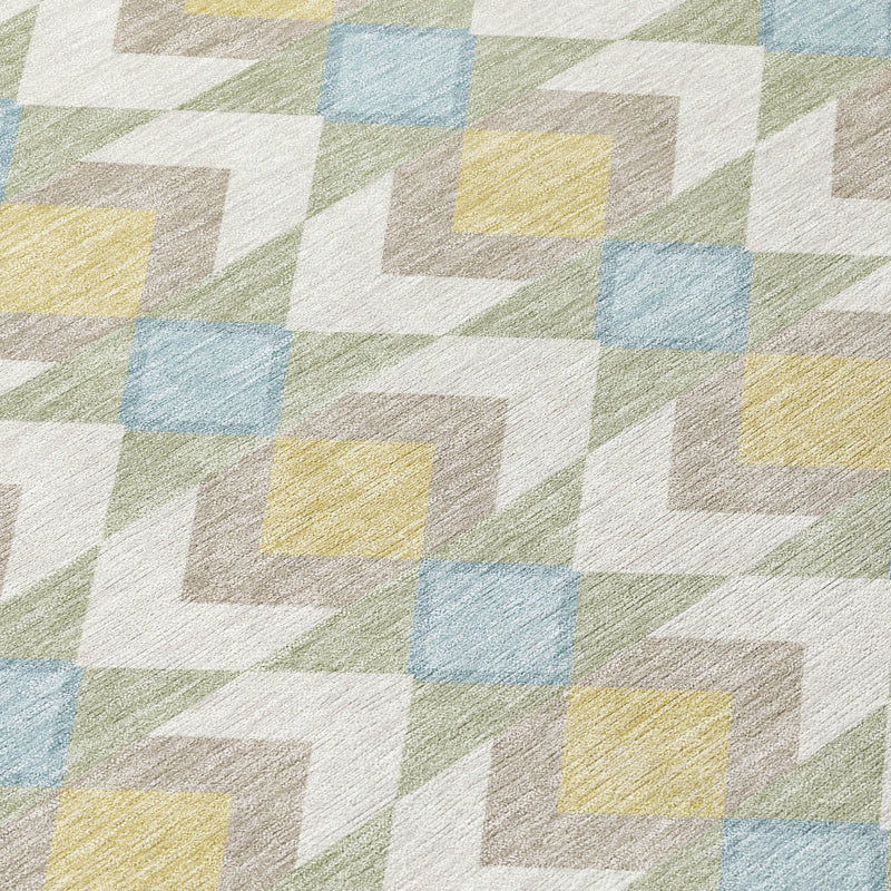 Close-up of ivory area rug with blue, yellow, green, and gray geometric chevrons