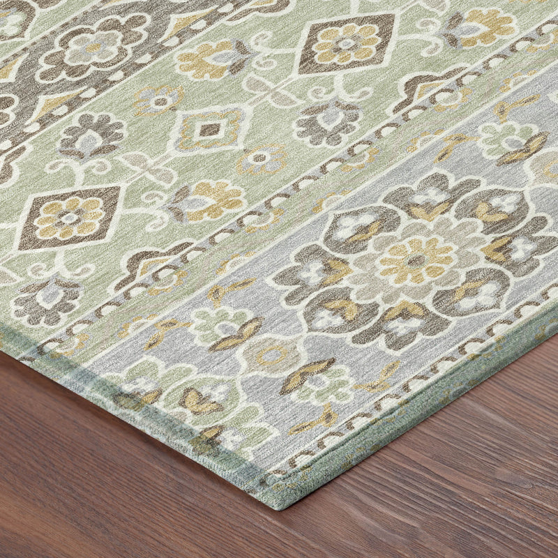 Green and ivory tribal area rug corner with ornate floral pattern