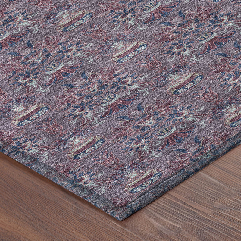 Corner view of plum and gray area rug with ornate floral medallion pattern.